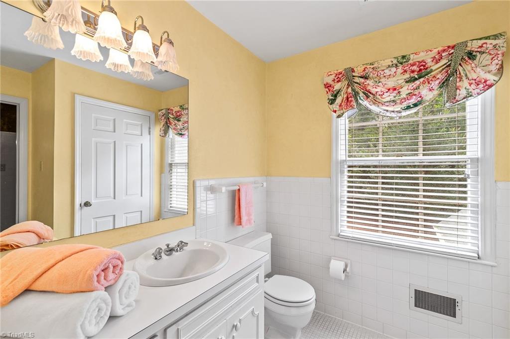 1318 Robinhood Road High Point, NC 27262 - Photo 36 of 43 Upstairs hallway with vanity and commode, shoer/tub combo situated between each private vanity area