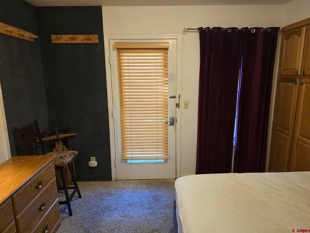 a bed room with a bed and a window