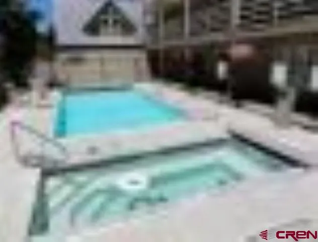 a view of a field with trees in background