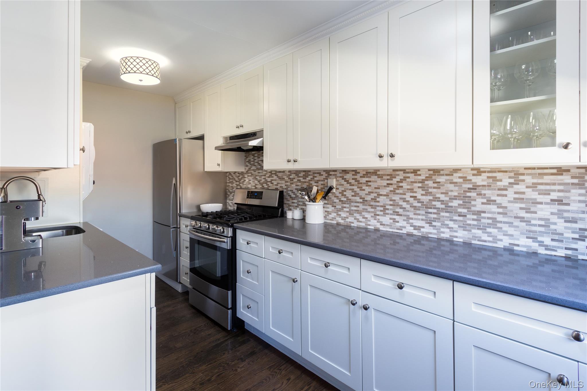 163-62 Willets Point Boulevard, Unit UPPR Queens, NY 11357 - Photo 11 of 19 a kitchen with granite countertop a sink stainless steel appliances and cabinets