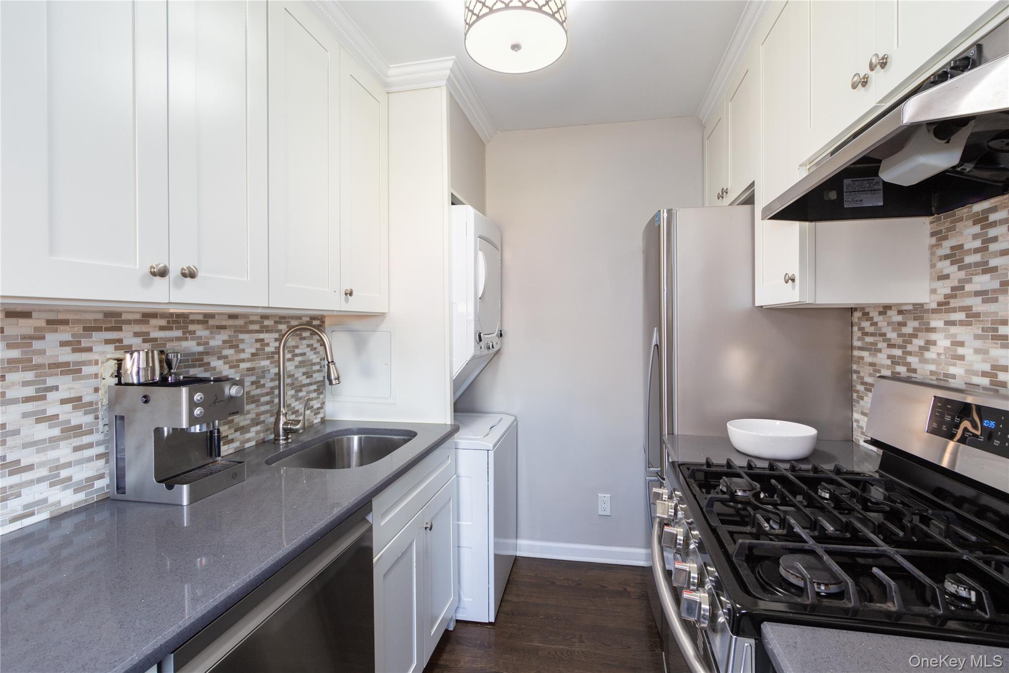 163-62 Willets Point Boulevard, Unit UPPR Queens, NY 11357 - Photo 13 of 19 a kitchen with a sink stove and refrigerator