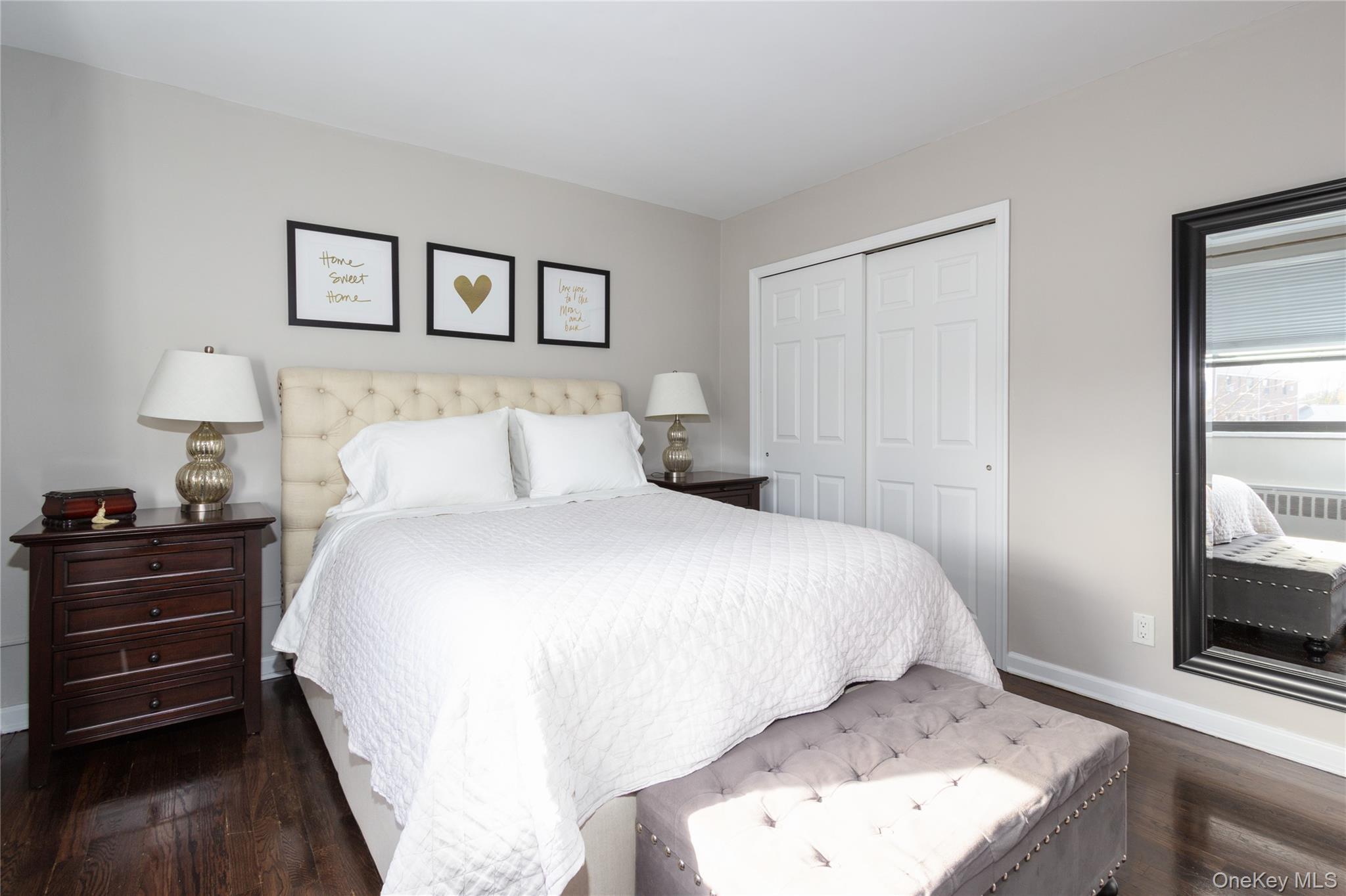 163-62 Willets Point Boulevard, Unit UPPR Queens, NY 11357 - Photo 15 of 19 a bedroom with a bed and a flat tv screen on the dresser