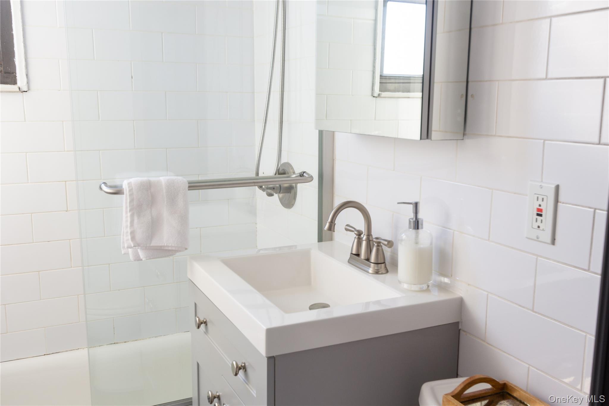 163-62 Willets Point Boulevard, Unit UPPR Queens, NY 11357 - Photo 17 of 19 a bathroom with a sink and a mirror