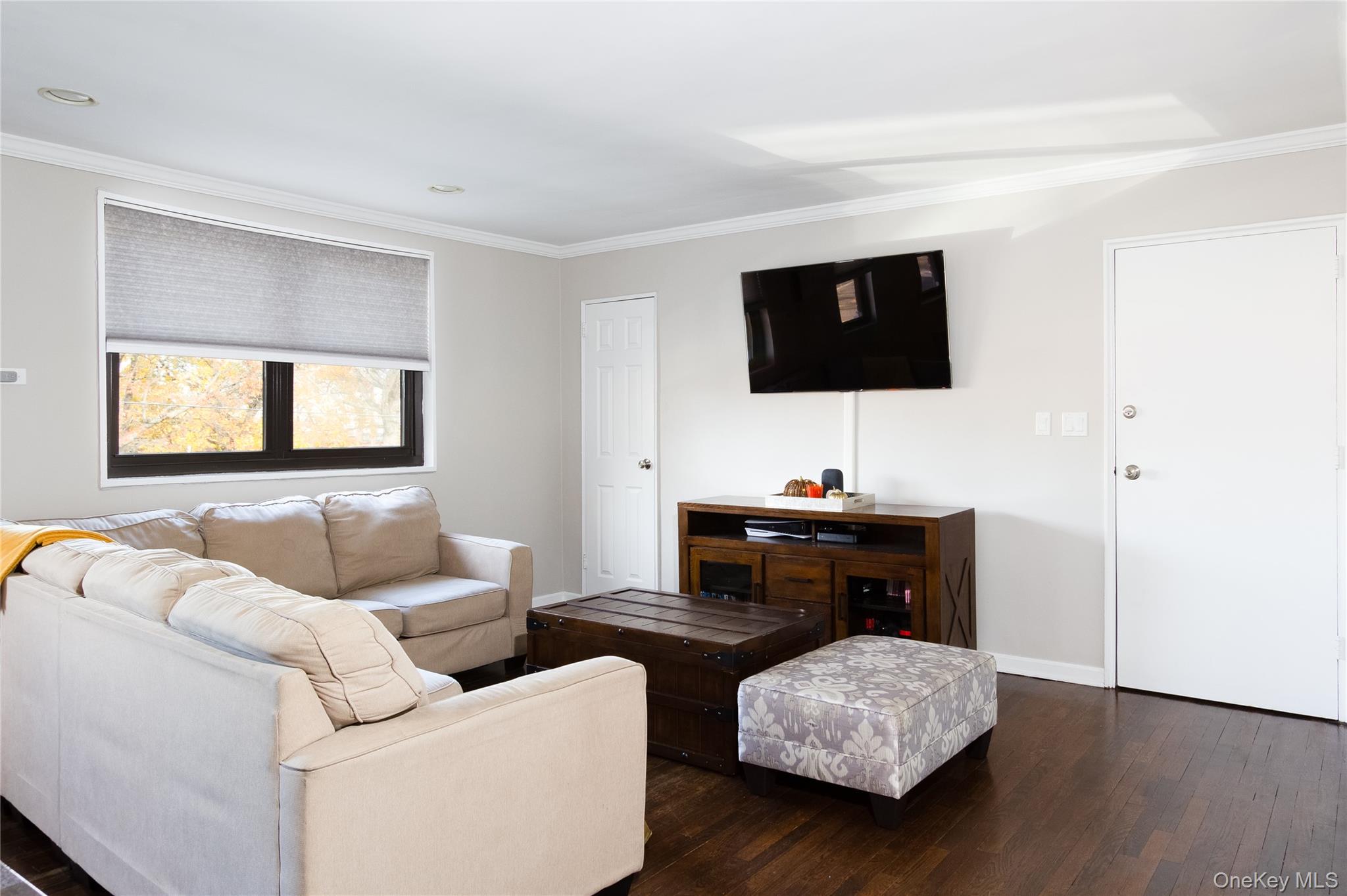 163-62 Willets Point Boulevard, Unit UPPR Queens, NY 11357 - Photo 7 of 19 a living room with furniture and a flat screen tv