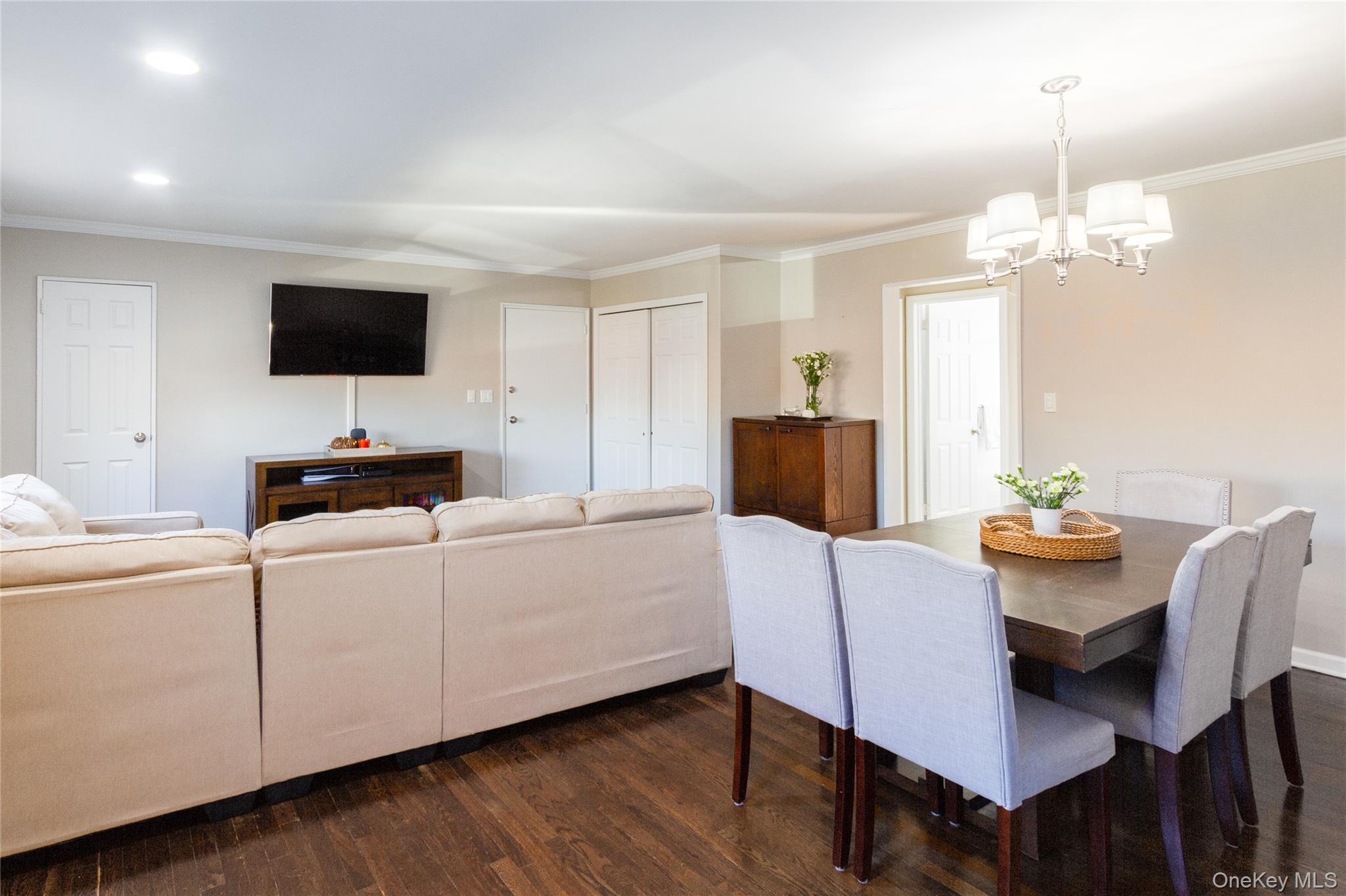 163-62 Willets Point Boulevard, Unit UPPR Queens, NY 11357 - Photo 8 of 19 a living room with furniture a flat screen tv and a dining table