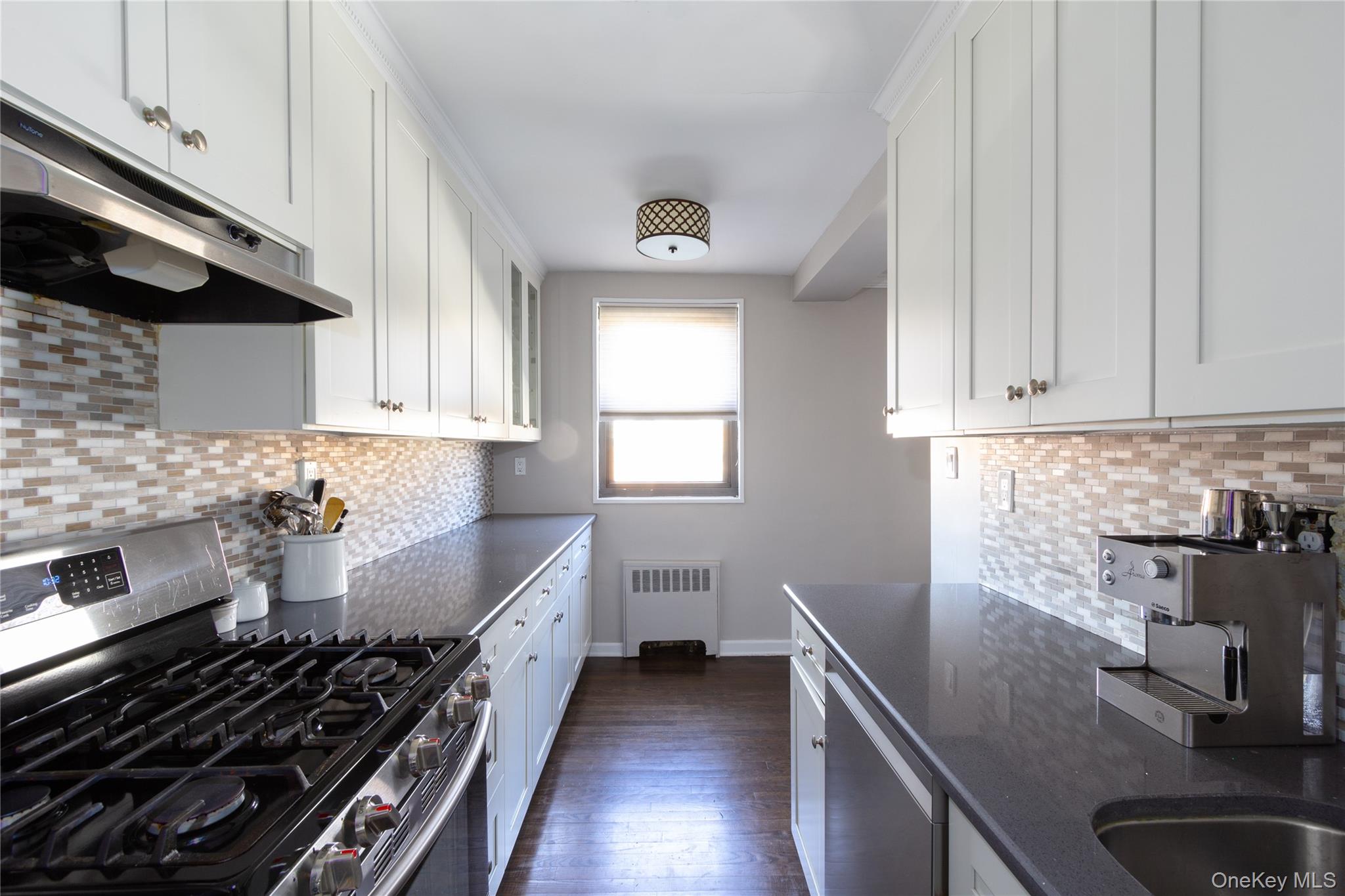 163-62 Willets Point Boulevard, Unit UPPR Queens, NY 11357 - Photo 10 of 19 a kitchen with a sink stove and microwave