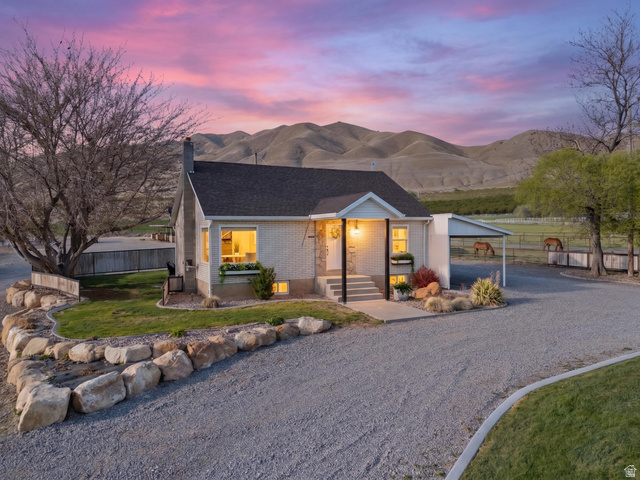 115 East 1600th Street North Santaquin, UT 84655 - Photo 41 of 52 Single-story residence featuring light-colored brick siding, a dark shingle roof, and a covered porch entry