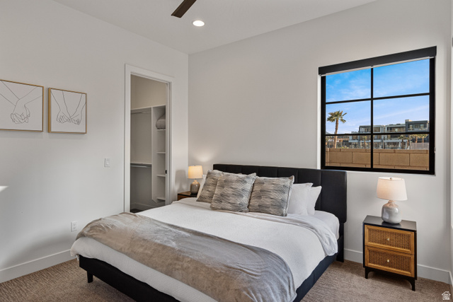 5367 Cyan Lane St. George, UT 84790 - Photo 5 of 49 Carpeted bedroom featuring a large window with black grid panes, a built-in closet with shelving, a ceiling fan, and recessed lighting