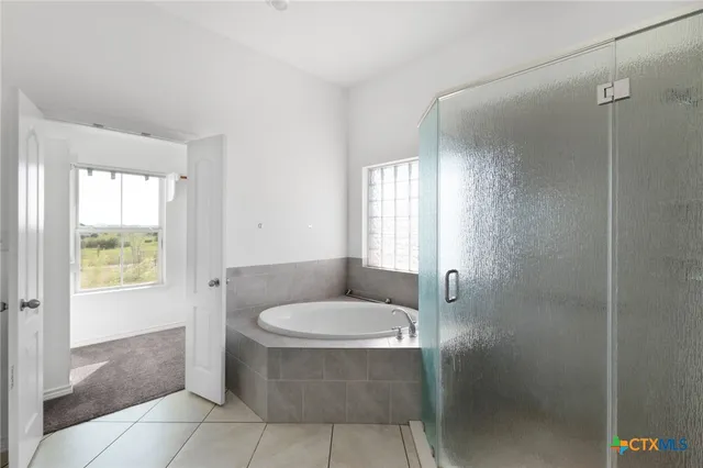 a bathroom with a tub and window