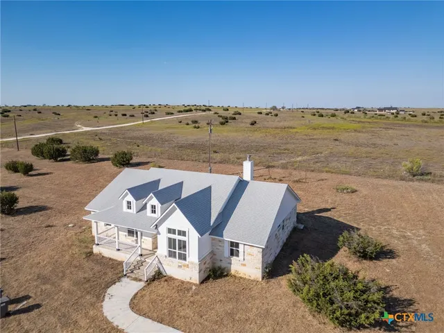 an aerial view of a house with a ocean view