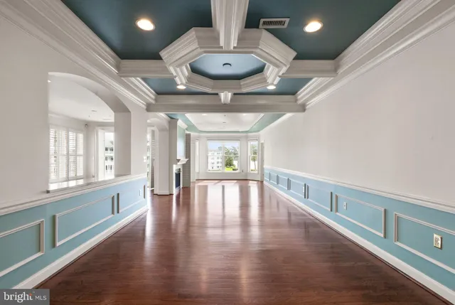 a dining room with furniture a window and wooden floor