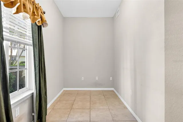 a view of a hallway with windows and entryway