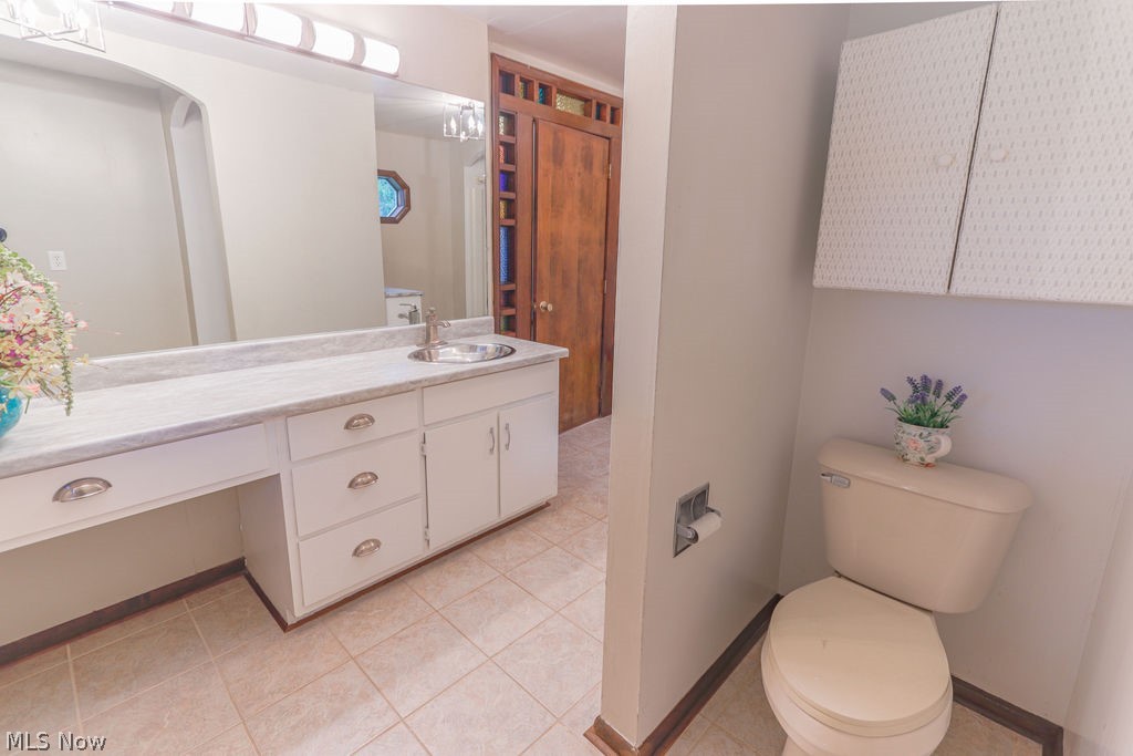 51883 Telegraph Road Amherst, OH 44001 - Photo 27 of 49 Bathroom featuring vanity, tile patterned floors, and toilet