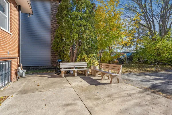 a backyard of a house with table and chairs