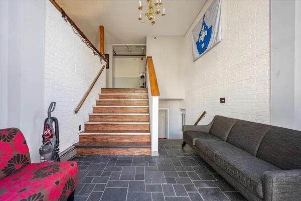 a living room with furniture and stairs
