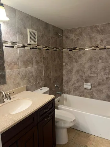 a bathroom with a sink a toilet and a bathtub