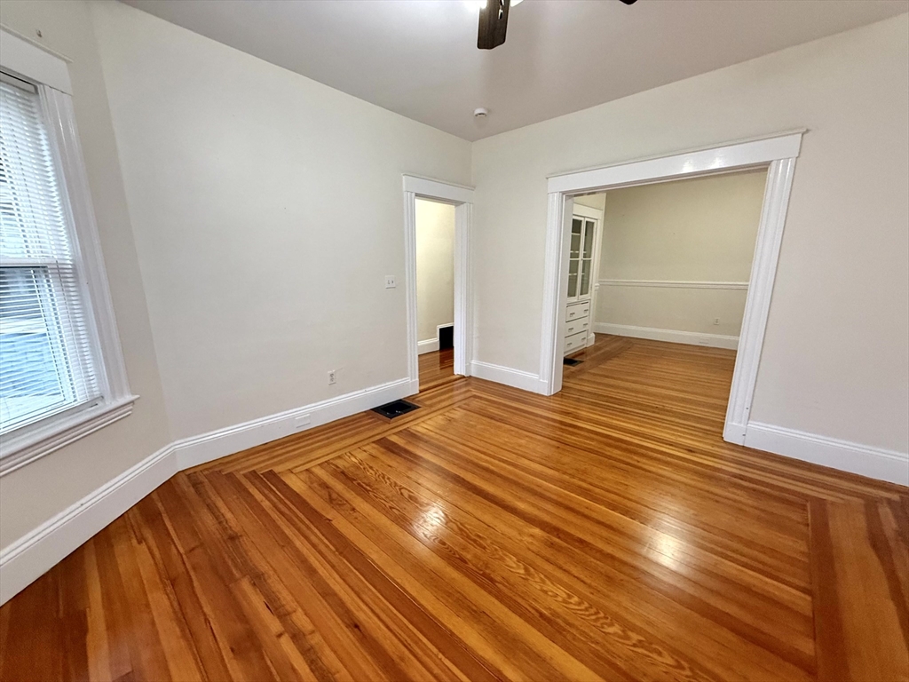 23 Park Road, Unit 23 Belmont, MA 02478 - Photo 11 of 21 an empty room with wooden floor and windows
