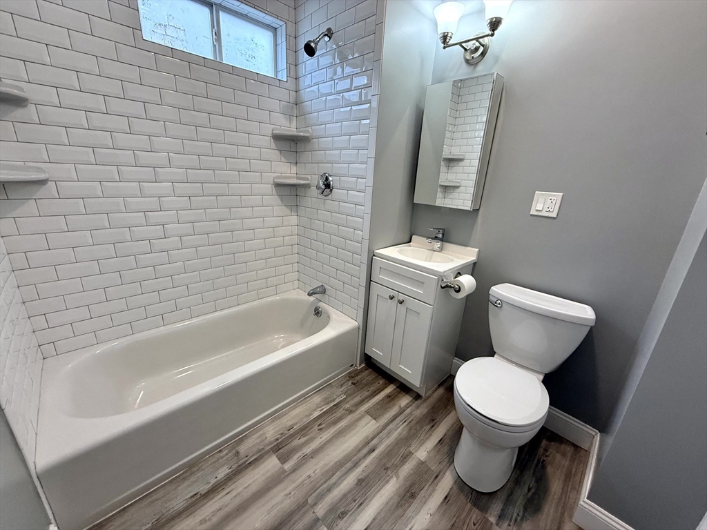 23 Park Road, Unit 23 Belmont, MA 02478 - Photo 12 of 21 a bathroom with a toilet sink and mirror
