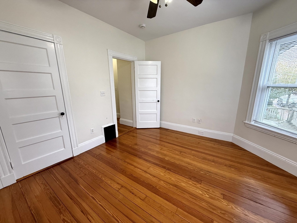 23 Park Road, Unit 23 Belmont, MA 02478 - Photo 16 of 21 wooden floor in an empty room with a window