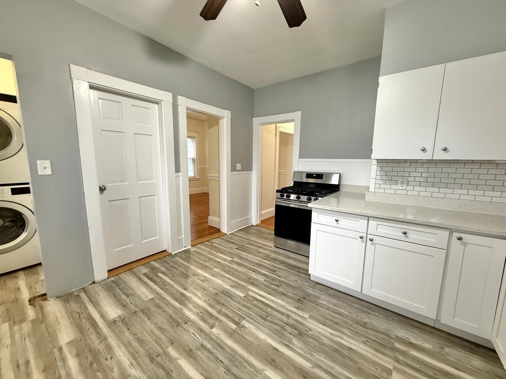 23 Park Road, Unit 23 Belmont, MA 02478 - Photo 2 of 21 a kitchen with granite countertop a stove and a refrigerator