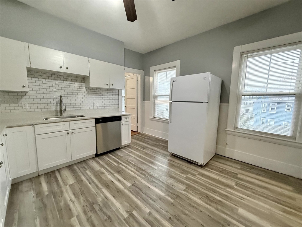 23 Park Road, Unit 23 Belmont, MA 02478 - Photo 3 of 21 a kitchen with a refrigerator sink and cabinets