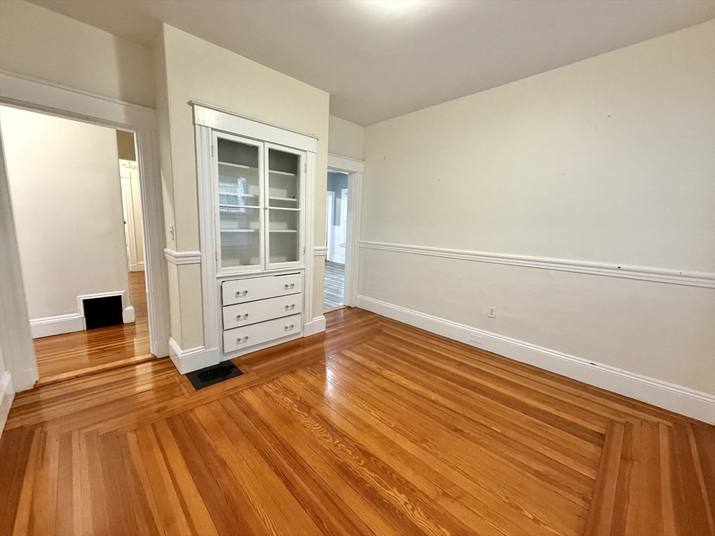 23 Park Road, Unit 23 Belmont, MA 02478 - Photo 6 of 21 a view of an empty room with wooden floor and a window