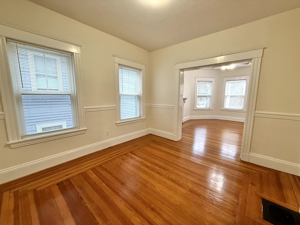 23 Park Road, Unit 23 Belmont, MA 02478 - Photo 7 of 21 a view of an empty room with wooden floor and a window