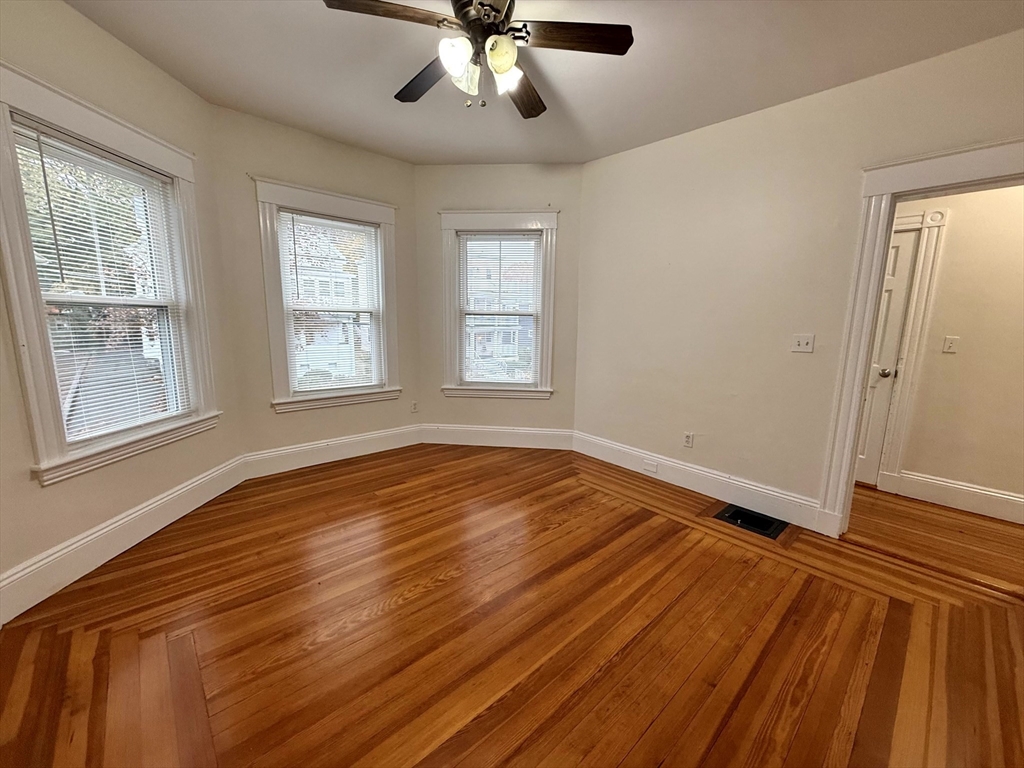 23 Park Road, Unit 23 Belmont, MA 02478 - Photo 8 of 21 a view of empty room with wooden floor and fan