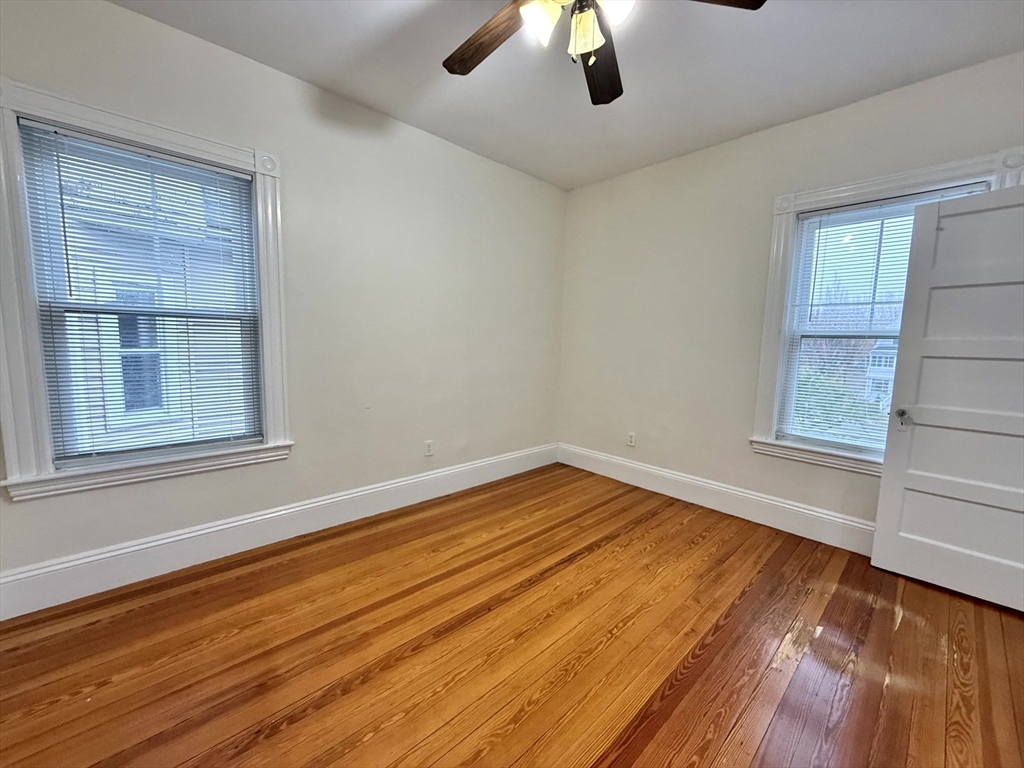 23 Park Road, Unit 23 Belmont, MA 02478 - Photo 10 of 21 a view of empty room with wooden floor and fan