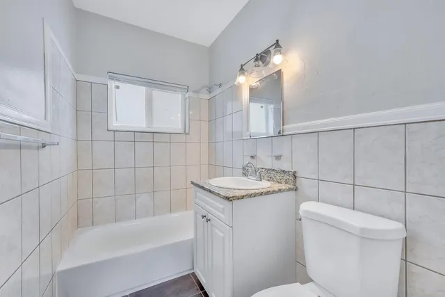 a bathroom with a sink a toilet and bathtub