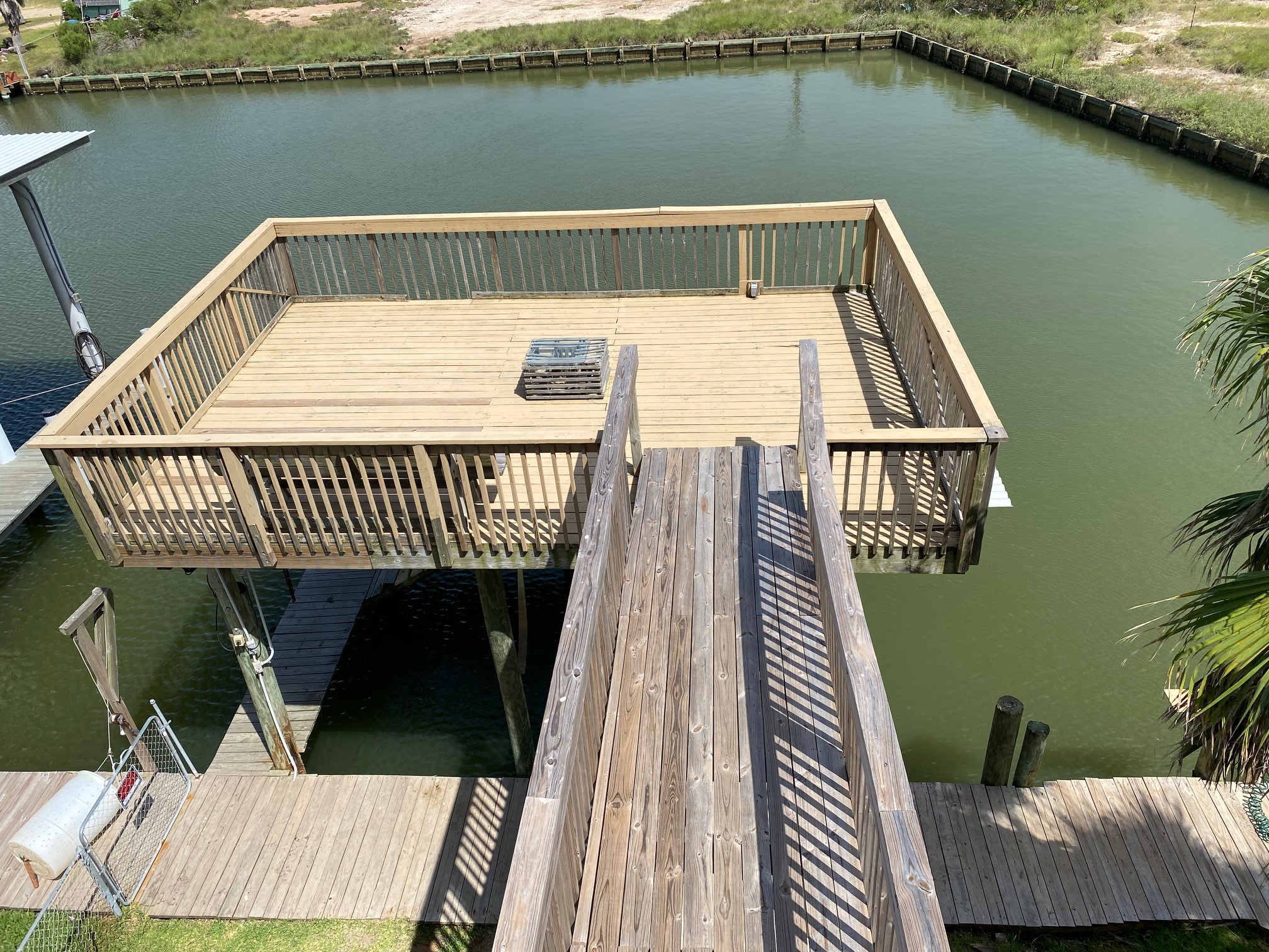 106 Pompano Lane Surfside Beach, TX 77541 - Photo 36 of 39 Sundeck over Boat Lift & Walkway from Porch Deck