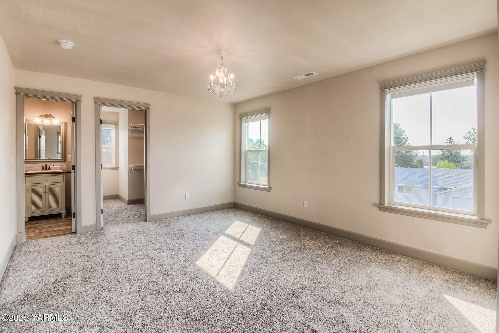 221 4th Avenue Zillah, WA 98953 - Photo 17 of 32 an empty room with chandelier fan and windows