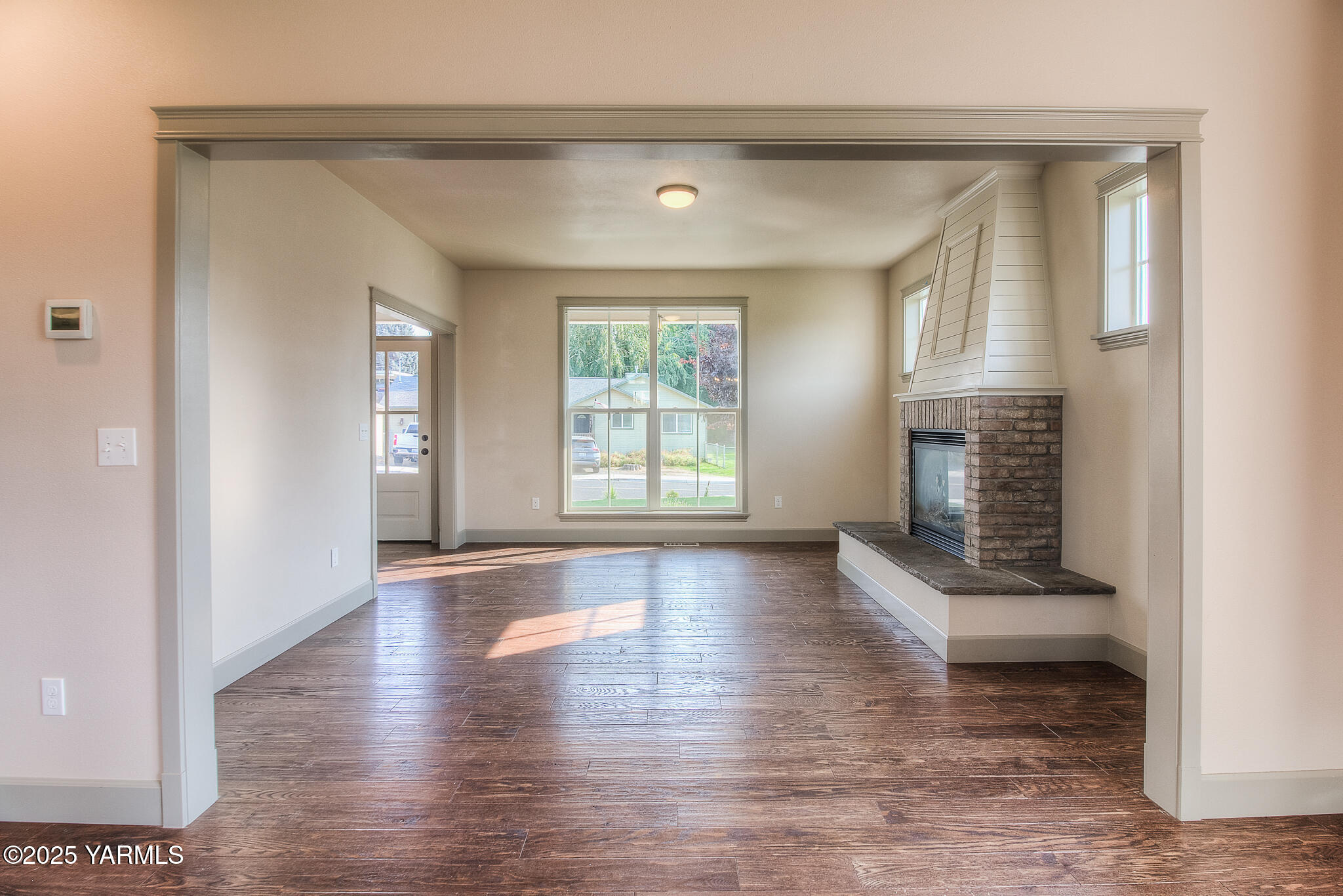 221 4th Avenue Zillah, WA 98953 - Photo 7 of 32 a view of an empty room with wooden floor and a window