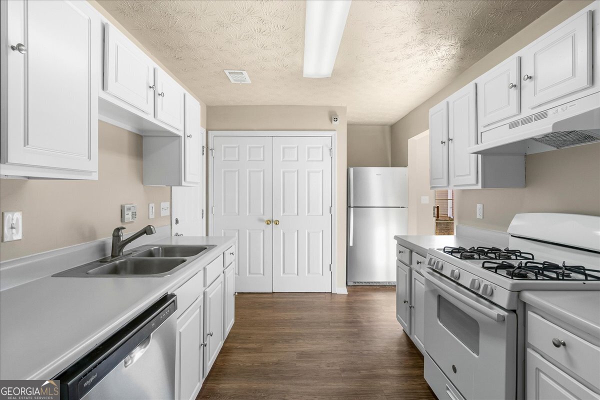 2603 Old Rex Morrow Road Ellenwood, GA 30294 - Photo 15 of 32 a kitchen with granite countertop a sink stove and refrigerator