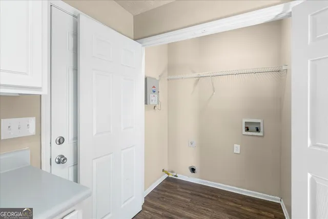 an empty room with wooden floor and a ceiling fan