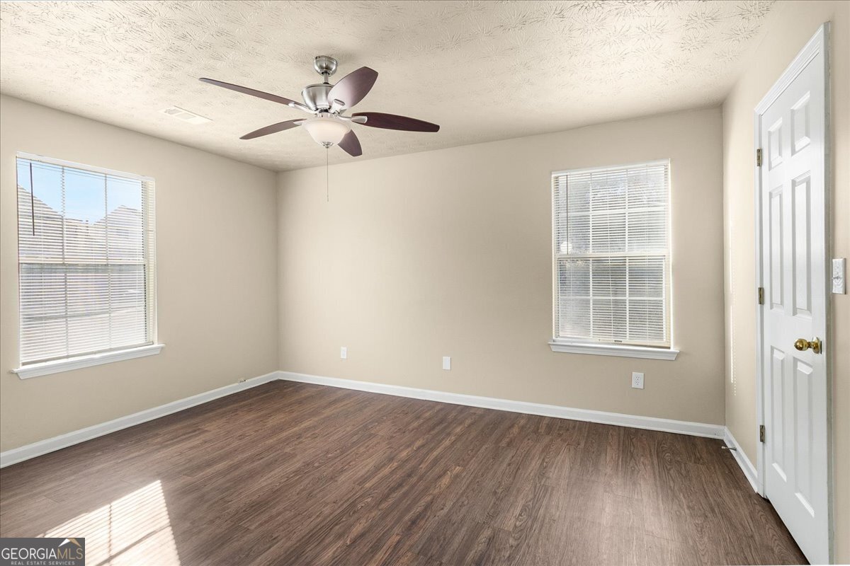 2603 Old Rex Morrow Road Ellenwood, GA 30294 - Photo 18 of 32 wooden floor in an empty room with a window