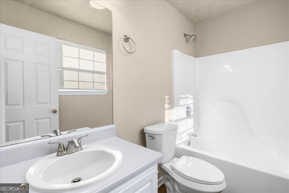 2603 Old Rex Morrow Road Ellenwood, GA 30294 - Photo 20 of 32 a bathroom with a sink a toilet and tub