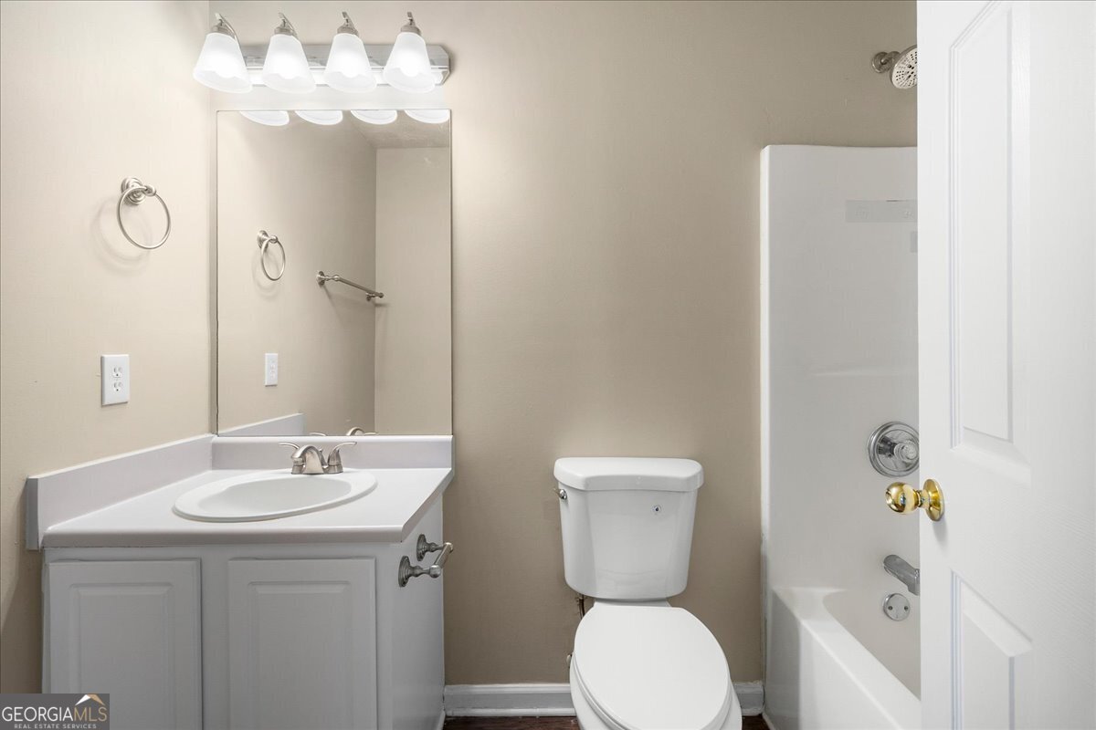 2603 Old Rex Morrow Road Ellenwood, GA 30294 - Photo 24 of 32 a bathroom with a sink a toilet and shower curtain