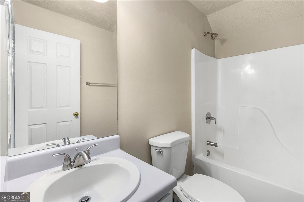 2603 Old Rex Morrow Road Ellenwood, GA 30294 - Photo 26 of 32 a bathroom with a sink toilet and shower