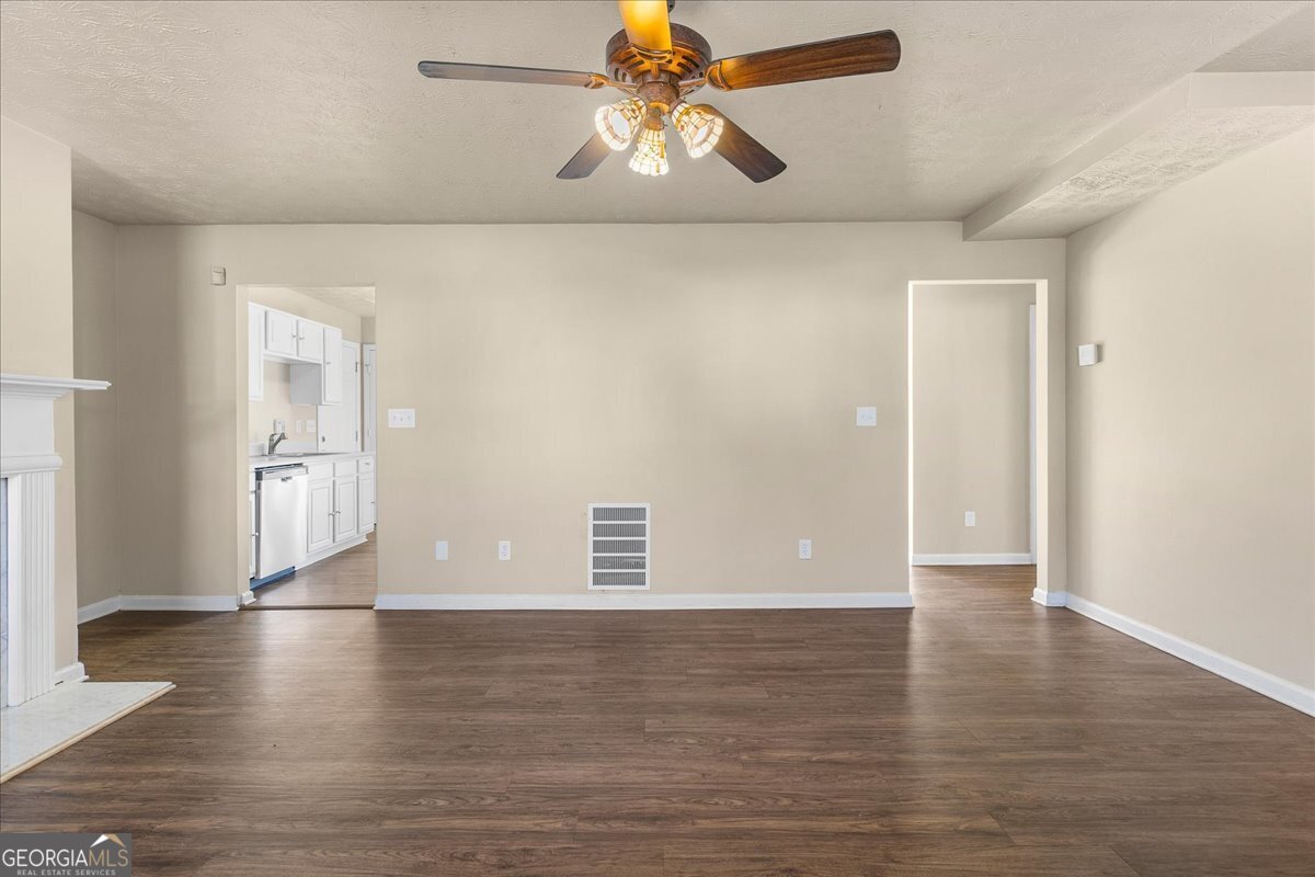 2603 Old Rex Morrow Road Ellenwood, GA 30294 - Photo 9 of 32 a view of a livingroom with wooden floor and a ceiling fan