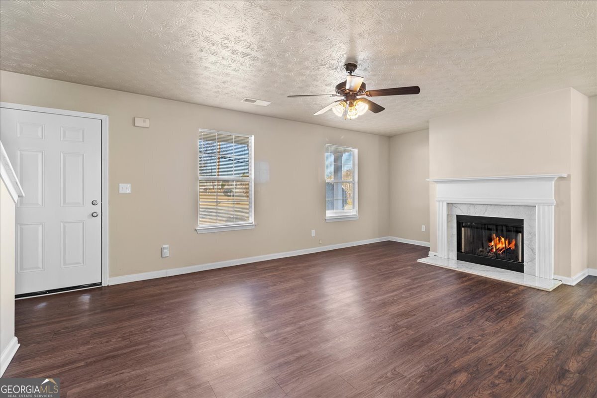2603 Old Rex Morrow Road Ellenwood, GA 30294 - Photo 10 of 32 a view of an empty room with wooden floor fireplace and a window