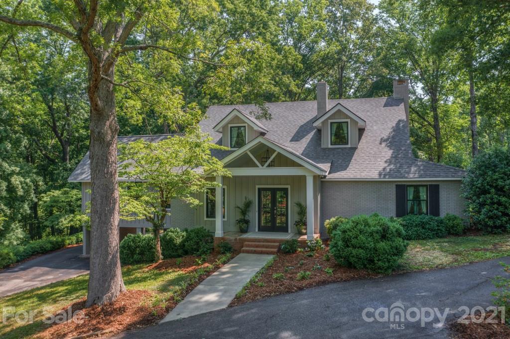 202 Blockhouse Road Landrum, SC 29356 - Photo 1 of 45 a front view of a house with garden