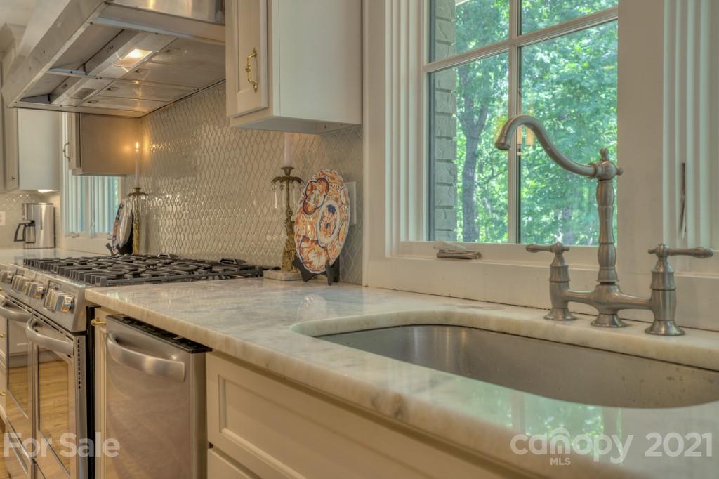 202 Blockhouse Road Landrum, SC 29356 - Photo 14 of 45 a bathroom with a granite countertop sink and a large mirror