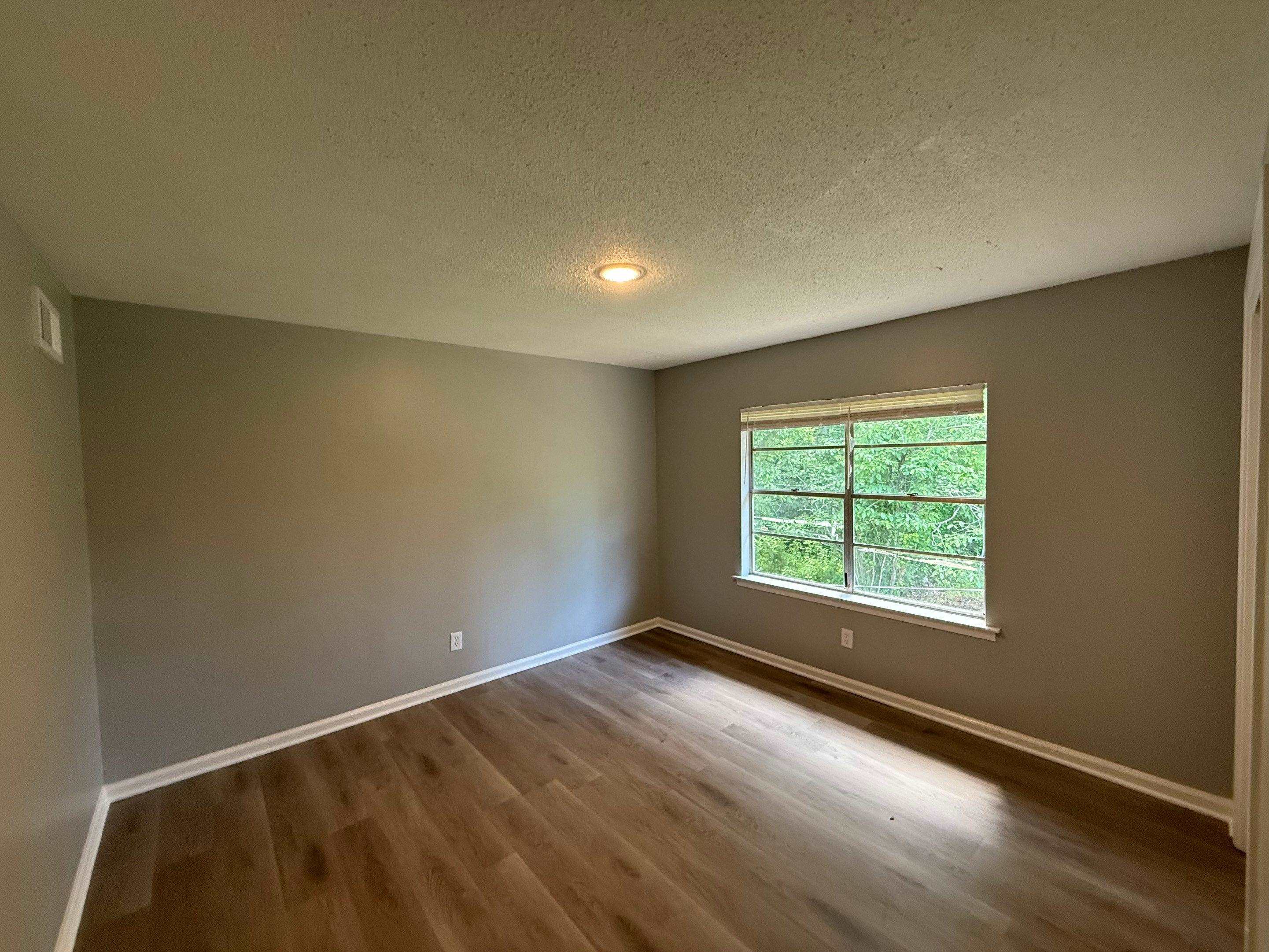 4603 Deer Valley Road Memphis, TN 38109 - Photo 6 of 6 Unfurnished room with dark wood-style floors and a textured ceiling
