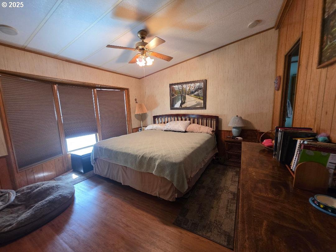 358 Oak Park Place Wamic, OR 97063 - Photo 14 of 29 a bedroom with a bed and wooden floor