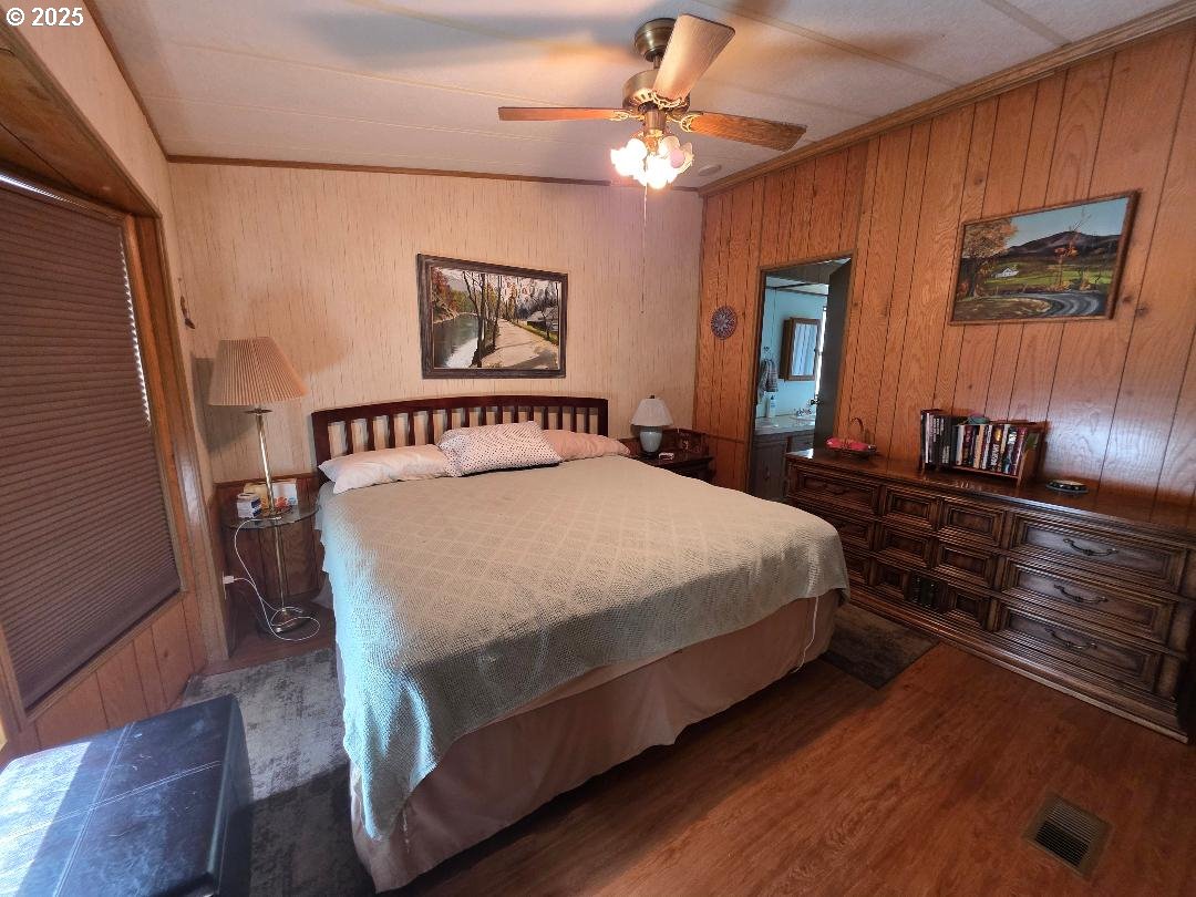 358 Oak Park Place Wamic, OR 97063 - Photo 15 of 29 a bedroom with a bed and a chandelier