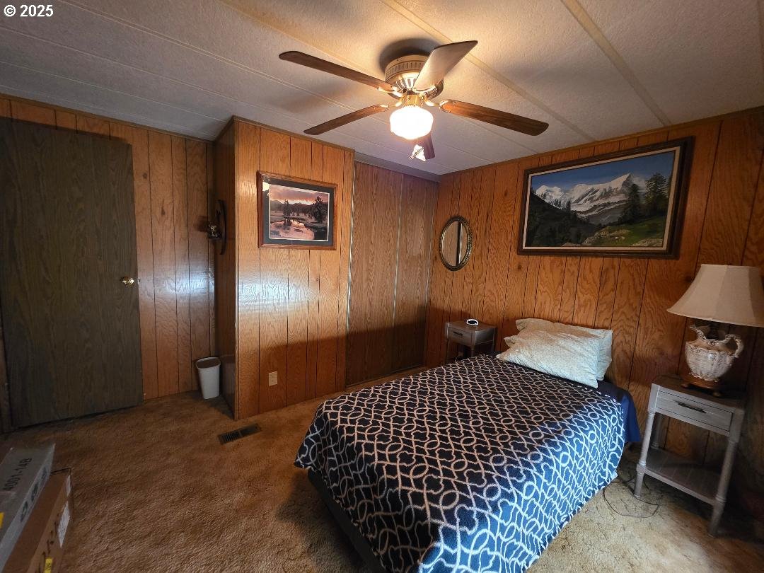 358 Oak Park Place Wamic, OR 97063 - Photo 18 of 29 a bedroom with a bed and painting on the wall