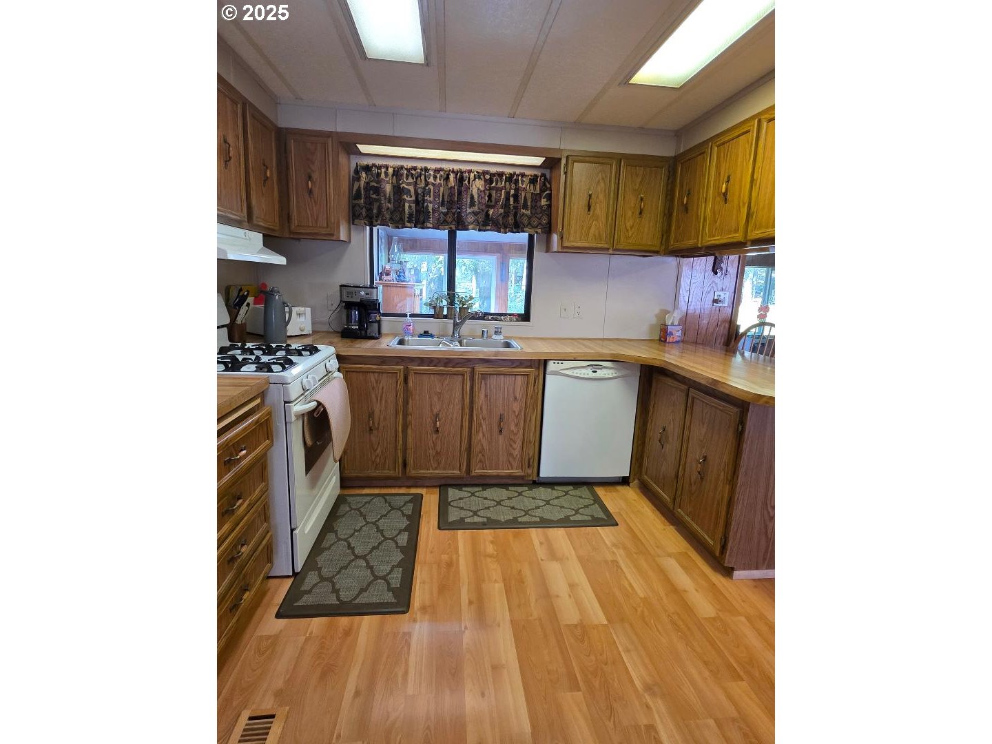 358 Oak Park Place Wamic, OR 97063 - Photo 6 of 29 a kitchen with a sink and cabinets