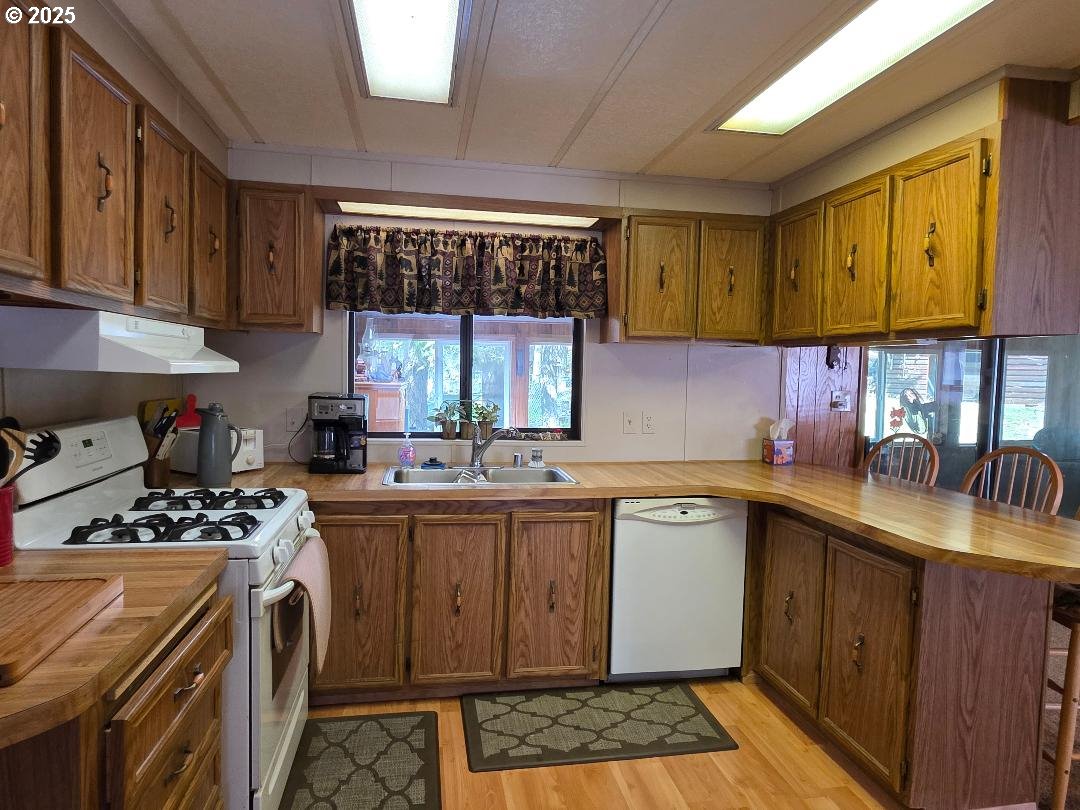 358 Oak Park Place Wamic, OR 97063 - Photo 7 of 29 a kitchen with a sink stove and cabinets