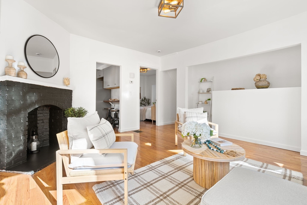 19 Berkley Road Hull, MA 02045 - Photo 15 of 42 a living room with furniture a fireplace and a table